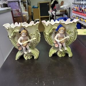 Ceramic angels play a banjo vase